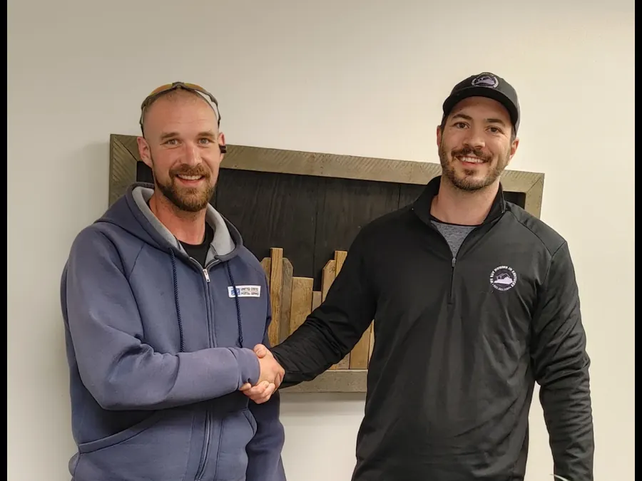 Dan shaking hands with a seller after closing